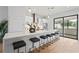Modern kitchen featuring quartz countertops, a breakfast bar, stainless steel appliances, and stylish lighting at 532 W Plaza Pl # 3, Tampa, FL 33602
