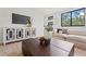 Stylish living room boasts a large TV, mirrored sideboard, and comfortable neutral sectional at 532 W Plaza Pl # 3, Tampa, FL 33602