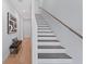 Bright staircase featuring modern railing, hardwood treads, and a black bench at 532 W Plaza Pl # 3, Tampa, FL 33602