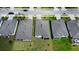 Aerial view of several homes with brick paver driveways on a lush, green street at 5336 Patano Loop, Palmetto, FL 34221