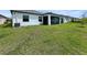 Exterior view of the house and yard showing the screened in patio and grass at 5336 Patano Loop, Palmetto, FL 34221