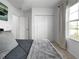 Bright bedroom featuring a cozy bed with soft gray bedding and a sunny window at 5336 Patano Loop, Palmetto, FL 34221
