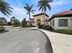 Inviting clubhouse entrance featuring lush landscaping, an arched entryway, and Mediterranean-style architecture at 5336 Patano Loop, Palmetto, FL 34221