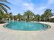 Stunning community pool surrounded by lush landscaping and lounge chairs at 5336 Patano Loop, Palmetto, FL 34221