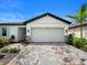 Exterior shot of the garage showing the neutral color scheme and brick paver driveway at 5336 Patano Loop, Palmetto, FL 34221