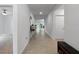 Hallway with neutral tile and views into the open floor plan at 5336 Patano Loop, Palmetto, FL 34221