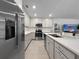 Bright kitchen featuring stainless steel appliances, white countertops, and an open design with views of the living area at 5336 Patano Loop, Palmetto, FL 34221