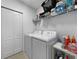 Functional laundry room with washer, dryer, and shelving for storage at 5336 Patano Loop, Palmetto, FL 34221