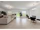 Bright and airy living room with tile flooring, large windows, and a sliding glass door to the outdoors at 5336 Patano Loop, Palmetto, FL 34221