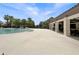 Expansive poolside patio with ample seating, shady pergolas, and views of the tropical landscape at 5336 Patano Loop, Palmetto, FL 34221