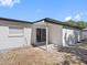 Private back patio offering shade and an entry door into the home at 5618 Halifax Dr, Tampa, FL 33615