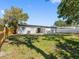 Expansive back yard featuring a large grassy area, privacy fence, and rear exterior of the home at 5618 Halifax Dr, Tampa, FL 33615