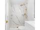 Sleek bathroom showcasing a marble-tiled shower, gold fixtures, built-in shelves, and a modern vanity at 5618 Halifax Dr, Tampa, FL 33615