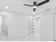 Well-lit bedroom featuring marble-look floors, recessed lights, ceiling fan, and access to a modern bathroom at 5618 Halifax Dr, Tampa, FL 33615