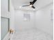 Bright bedroom showcasing marble-look tile flooring, modern ceiling fan, recessed lights, and a sleek door at 5618 Halifax Dr, Tampa, FL 33615