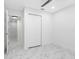 Well-lit bedroom features marble-look floors, a ceiling fan, a closet, and views into an adjacent room at 5618 Halifax Dr, Tampa, FL 33615
