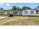 Charming single-story home featuring a bright white exterior, black trim, and a cozy covered carport at 5618 Halifax Dr, Tampa, FL 33615
