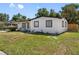 Beautiful single-story home featuring a bright white exterior, black trim, and a well-maintained lawn at 5618 Halifax Dr, Tampa, FL 33615