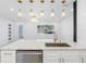 Bright, open-concept kitchen featuring a quartz countertop, modern lighting, and stainless-steel appliances at 5618 Halifax Dr, Tampa, FL 33615