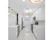 Long view of the kitchen features granite counters, stainless appliances, and pendant lighting at 5618 Halifax Dr, Tampa, FL 33615