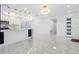 Bright open concept kitchen boasts quartz counters, stainless appliances, modern lighting, and marble-look tile at 5618 Halifax Dr, Tampa, FL 33615