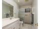 Bright bathroom featuring a vanity, sink, toilet and a glass shower with sliding doors and convenient grab bars at 60 Birdsong Ct, Oldsmar, FL 34677