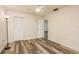 Cozy bedroom with wood-look floors, features a closet, ceiling fan, lamp and neutral decor for a comfortable retreat at 60 Birdsong Ct, Oldsmar, FL 34677