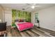 Comfortable bedroom with wood-look flooring and closet space at 60 Birdsong Ct, Oldsmar, FL 34677