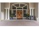 Welcoming front entrance with double doors, beautiful landscaping, and elegant architectural details at 60 Birdsong Ct, Oldsmar, FL 34677