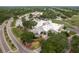 Aerial view of the clubhouse entrance with manicured landscaping and convenient parking at 60 Birdsong Ct, Oldsmar, FL 34677