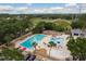 Aerial view of a resort-style pool with lap lanes, leisure area, and lush landscaping in a vibrant community at 60 Birdsong Ct, Oldsmar, FL 34677