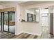 Open dining area with breakfast bar, tile floors and views of the outdoor tiled spa area at 60 Birdsong Ct, Oldsmar, FL 34677