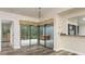 Dining area featuring tile flooring, chandelier, and sliding glass doors to a tiled outdoor spa area at 60 Birdsong Ct, Oldsmar, FL 34677