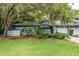 Charming single-story home with a well-manicured lawn and mature trees in a serene setting at 60 Birdsong Ct, Oldsmar, FL 34677
