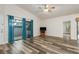 Living room with ample natural light, wood-look floors, and a sliding glass door at 60 Birdsong Ct, Oldsmar, FL 34677
