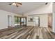 Spacious living room features sleek flooring, bright lighting, and access to the patio at 60 Birdsong Ct, Oldsmar, FL 34677