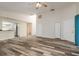 Open-concept living room with modern flooring, neutral paint, and a versatile layout at 60 Birdsong Ct, Oldsmar, FL 34677