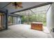 Screened-in patio with a hot tub, offers a serene outdoor space to enjoy nature and the comfort of a private spa at 60 Birdsong Ct, Oldsmar, FL 34677