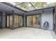 Enclosed patio with sliding glass doors, offering views into the home's living spaces, blending indoor and outdoor living at 60 Birdsong Ct, Oldsmar, FL 34677