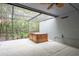 Screened-in patio featuring a hot tub, offering a private retreat surrounded by lush greenery for relaxation and enjoyment at 60 Birdsong Ct, Oldsmar, FL 34677