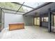 Enclosed patio with a hot tub, providing a seamless transition to the indoors and an outdoor bar for entertainment at 60 Birdsong Ct, Oldsmar, FL 34677
