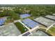 Aerial view of a community pickleball complex with multiple courts and shaded seating areas for players at 60 Birdsong Ct, Oldsmar, FL 34677
