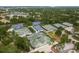 Aerial view of tennis and pickleball courts surrounded by lush trees, offering recreation in a scenic community at 60 Birdsong Ct, Oldsmar, FL 34677