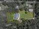 Aerial view of home showcasing pool, privacy and serene location of the property at 7427 20Th St, Zephyrhills, FL 33540
