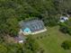 Estate aerial view showcases a meticulously landscaped property surrounded by mature trees at 7427 20Th St, Zephyrhills, FL 33540