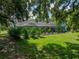 Spacious backyard showcasing the pool area, lush landscaping, and outdoor living space at 7427 20Th St, Zephyrhills, FL 33540