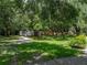 Spacious backyard with a storage shed and mature trees, offering both utility and natural beauty at 7427 20Th St, Zephyrhills, FL 33540