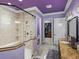 Spacious bathroom showcasing a walk-in shower, granite vanity, and an open door to the walk-in closet at 7427 20Th St, Zephyrhills, FL 33540