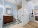 Airy bathroom displays a vanity, toilet and shower with a seashell-themed shower curtain at 7427 20Th St, Zephyrhills, FL 33540