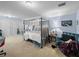 Comfortable bedroom with a four-poster bed, blue accent chair, and carpeted floor at 7427 20Th St, Zephyrhills, FL 33540